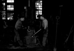 Midvale Company employees Raymond McConkey (left) Walter Kerby (center) and Lawrence Kennedy (right) making hooks for removing billetts from furnaces, April 20, 1948.