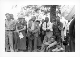 Black and White STFU members including Ben and Myrtle Lawrence, standing, and Olin Lawrence, seated in front, listen to Norman Thomas speak outside Parkin, Arkansas on September 12, 1937.