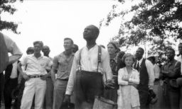 Men, women and children, including Ben, Myrtle and Icy Jewel Lawrence, listening to speakers at an outdoor STFU meeting
