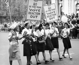 ILGWU women marching in a Labor Day parade with placards that read, "'60 is the year to vote reaction out."