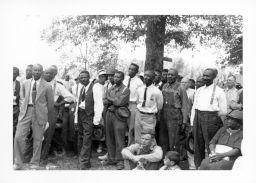 Black and White STFU members including Olin Lawrence, seated in front, listen to Norman Thomas speak outside Parkin, Arkansas on September 12, 1937.