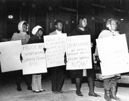African American workers picket with placards announcing their strike against the Wentworth Manufacturing Company and decrying police behavior and arrests of co-workers, 1968.