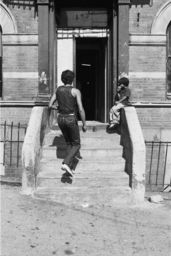 Man and boy on building stoop