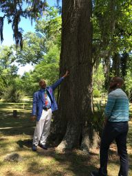 Johnnie Brown pointing out a whipping tree in Laurel Grove Cemetery