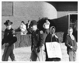 Lake City picket, with police protection.  A Wentworth picketer wears a sign that reads "Local 534 ILGWU on strike..."
