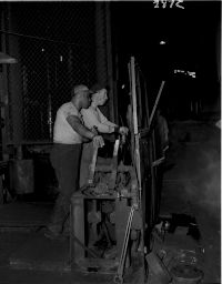 Midvale Company employees C.R. Smith Pyrometer, John Murtha with Calliper (driver), Schram and Joseph Hall at levers, April 8, 1954