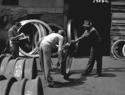 Midvale Company employee checking locomotive tires at shipping wharf, May 31, 1949