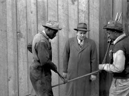 Midvale Company employees Terpier and Newt DeHann showing safe method of using alligator shears, 1947