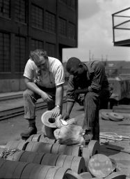 Midvale Company employees Harvey and Quintavalle at the ship wharf examining labels for pieces, July 1, 1946
