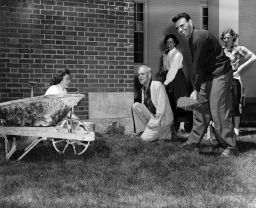 Students with wheelbarrow and shovel and President Johnson at "1941" cornerstone (Johnson Day?)