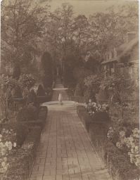 Garden path and fountain, estate visible to right