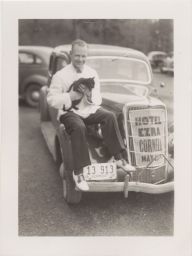Gert Hans Werner Schmidt, Hotel '38, chairman of the Board of Directors for Hotel Ezra Cornell, sitting on his car with mascot Thirteen