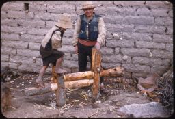 Vicos man and boy making fence posts