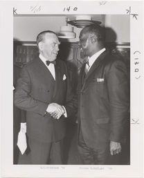 Eric Erickson shaking hands with Jerome H. Holland '39