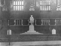 Statue of Young Benjamin Franklin by R. Tait McKenzie, projection of statue and base on photograph of front of Weightman Hall