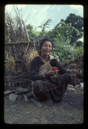 Karki gaun ko mahila unko dhago ko dalla pardai (कार्की गाउँको महिला ऊनको धागो गोलो पार्दै / Woman of Karki Village Spinning Wool Into Yarn)