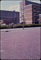 Two large residential buildings from across a brick-paved street (Delft, NL)