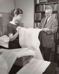 Man and a woman holding computer printout