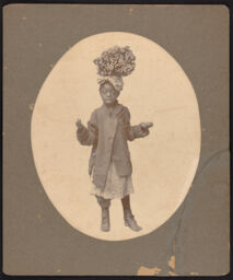 Young child with a bundle of sticks on her head