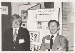 Psychiatrist Emery Hetrick and New York University Professor A. Damien Martin stand by an NGTF exhibit at the American Psychiatric Association Convention