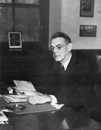 George W. McClelland (1880-1955), A.B. 1903, Ph.D. 1916, LL.D. 1931 (hon.), at his desk