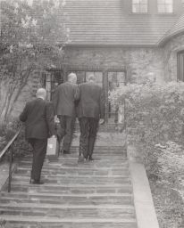 President Eisenhower acending the steps of Cornell President Mallot's House
