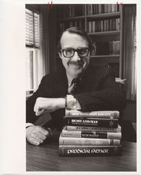 Roger Howley posing with books