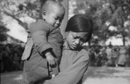 Mrs. Phyllis Lin (wife of Dr. Liang) holding 2-year-old son in Peking.