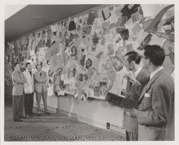 Hotel Ezra Cornell: Five male students standing at wall of international menus