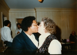 Two women kissing at party