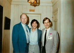 Three men in suits at a party