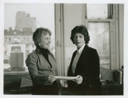 Lucia Valeska and Ginny Apuzzo holding a document together