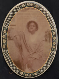 Portrait of a woman in an oval button frame