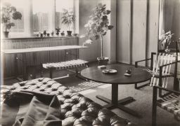 Room with seating and plant around round table