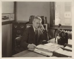 Lloyd R. Simons at his desk at the Central Farm Bureau Office