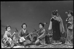 Several geisha, some with musical instruments