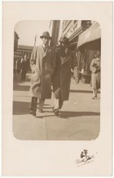 Two men in trench coats and hats