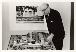 Thomas W. Mackesey with model of Cornell campus building plans.