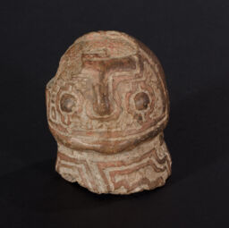 Hollow head fragment from small figurine with red paint and excision for negative effect