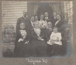 Family portrait in front of house, Topeka, Kansas