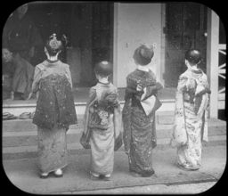 View of the backs of several girls in formal dress