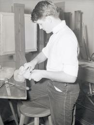 Student carving wooden ducks