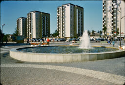 Public fountain and plaza with high-rise towers in the background (Vallingby, Stockholm, SE)