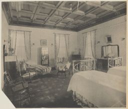 Bedroom with twin beds and light walls in Horne residence