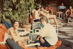 Two women smiling by poolside