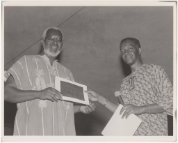 Jitu Weusi receiving a certificate from Mensah Wali