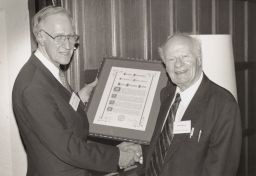 Hans Bethe accepting a certificate of appreciation from Cornell President Frank H. T. Rhodes