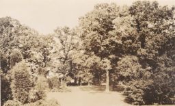 Benches in rear, trees, and lawn