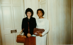 Two women with handbags at a party