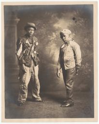 Two boys in tattered clothes